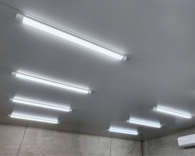 LED batten lights installed across a workshop ceiling